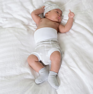 baby sleeping baby in basket wearing organic cotton white memeeno baby belly bloomer