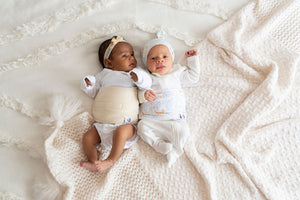 two babies one in luna band and hat and the other in naturelle band