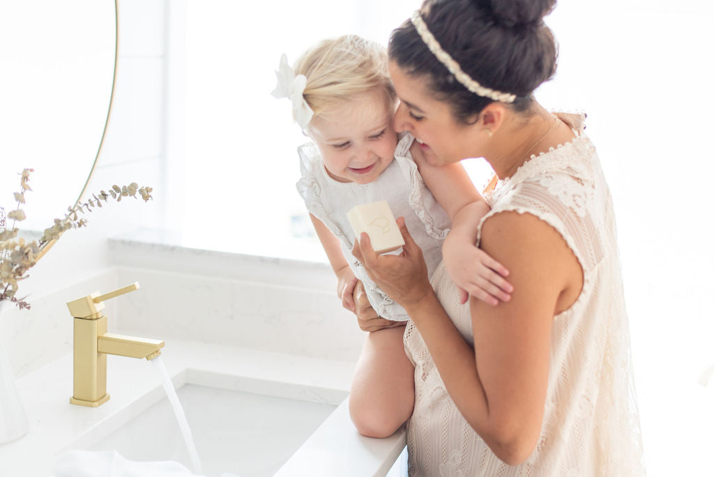 Mother holding baby and Memeeno Handmade Luxury Soap
