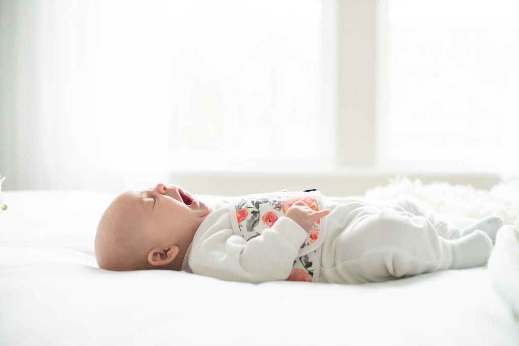 Baby laying down and yawning
