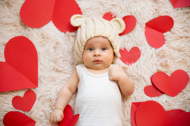 Baby with red hearts in the background