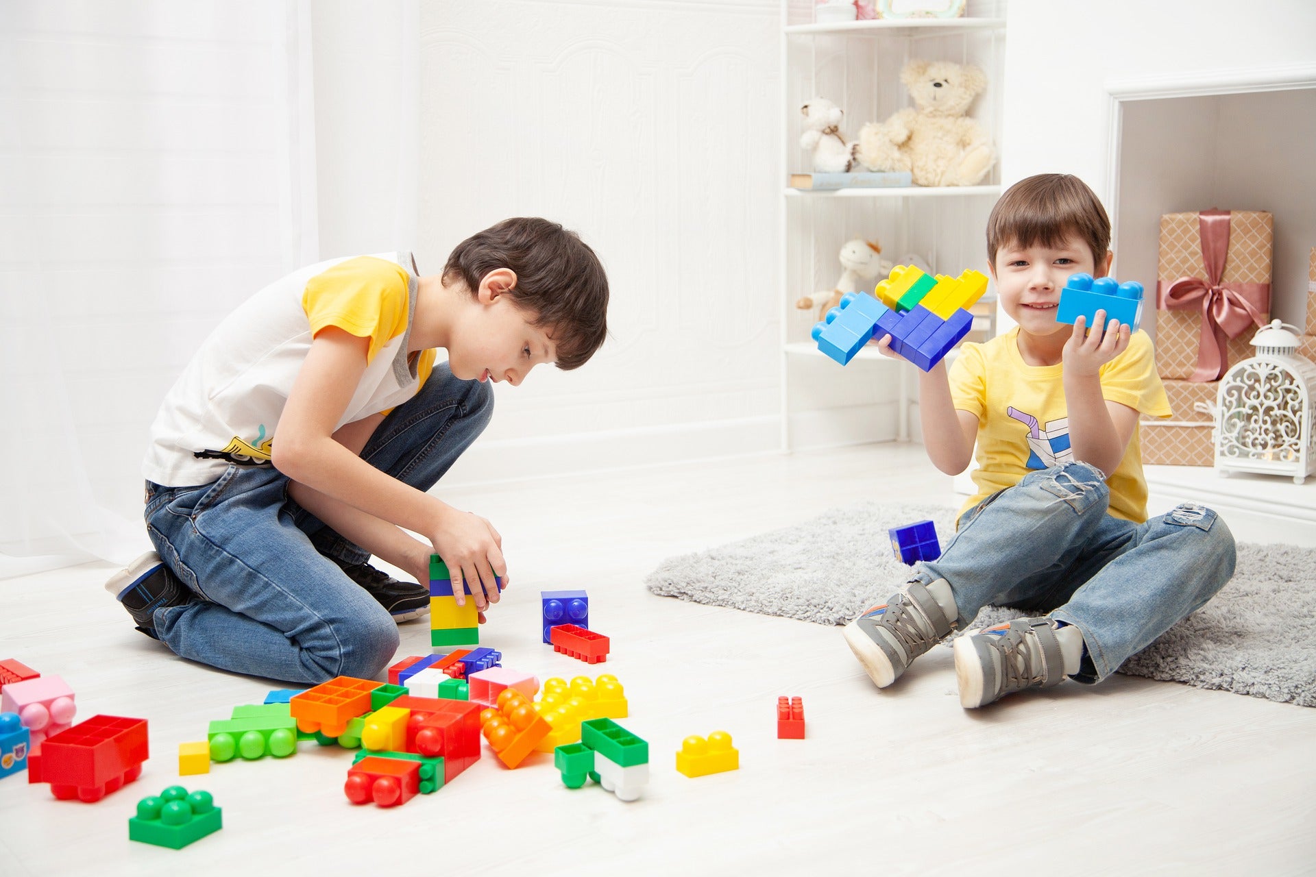 two boys playing colorful blocks