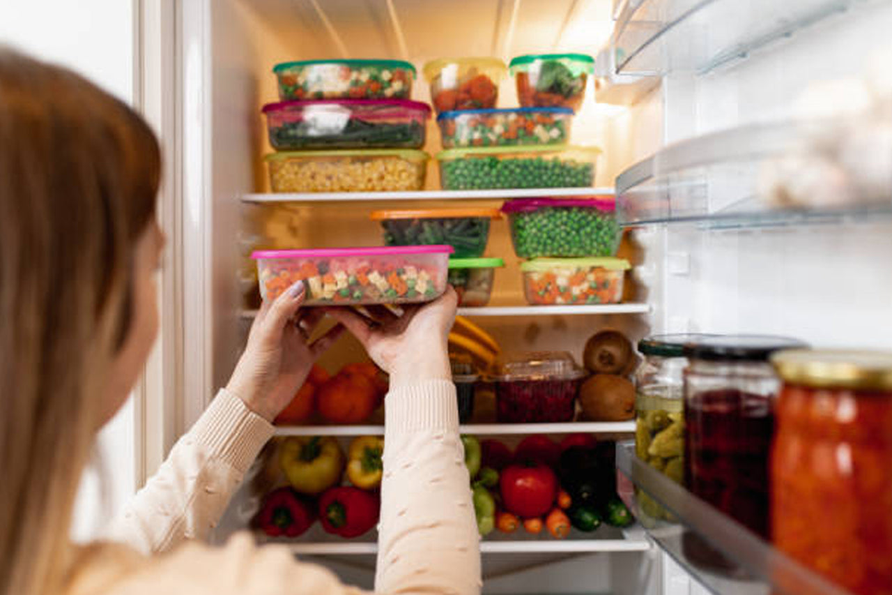 Woman organizing the fridge