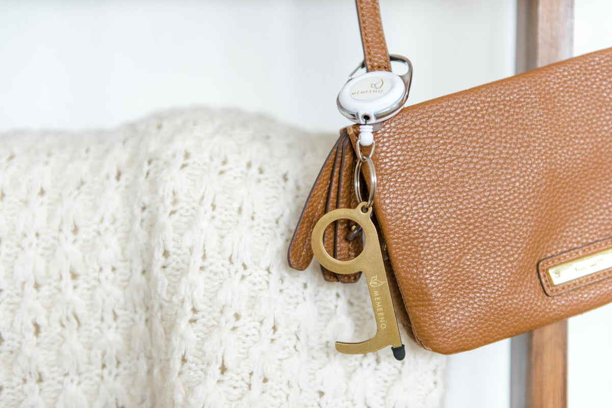 touchless keychain door opener on purse