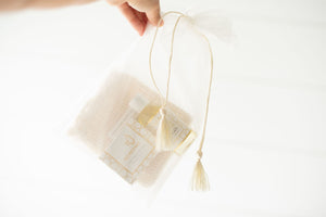 Sisal soap pouch, baby massage oil and all-natural olive oil soap in a see-through bag.