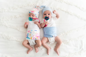 two babies in belly bands and top knot hats