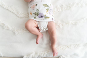 close up of baby wearing  organic cotton baby belly band darling, with florals