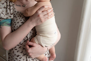 close-up of mom holding baby wearing naturelle unbleached cotton bloomer