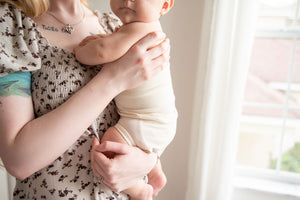 mom holding baby wearing naturelle unbleached cotton bloomer