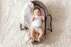 baby in basket wearing organic cotton white memeeno baby belly bloomer