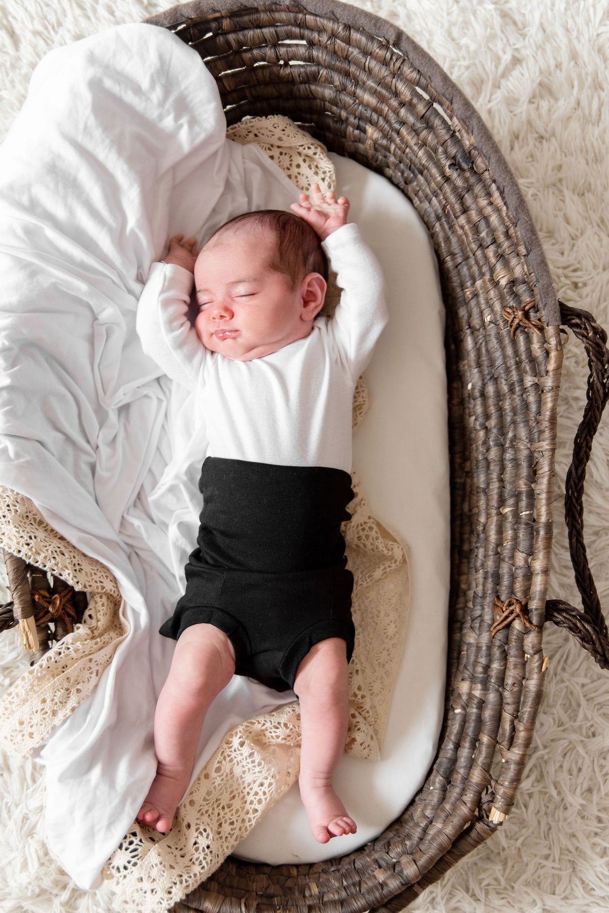 baby in basket wearing organic cotton black memeeno baby belly bloomer