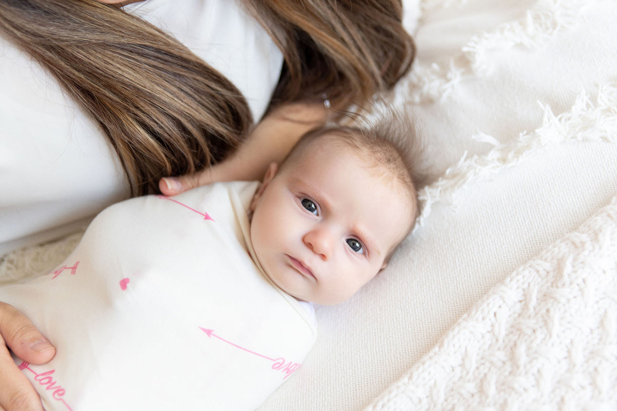 baby wrapped in pink Love her swaddle
