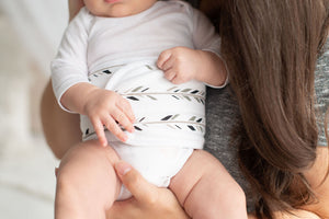 close up of baby wearing  organic cotton baby belly band feathers