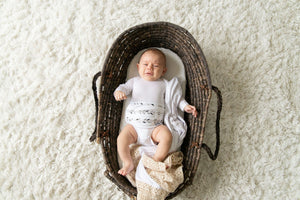 baby in basket wearing organic cotton feathers memeeno baby belly bloomer