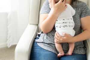 close up of mom holding feathers organic cotton memeeno baby belly bloomer