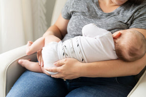 close up of mom holding baby wearing feathers organic cotton memeeno baby belly bloomer