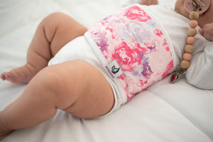 close up of memeeno bouquet belly band for colic relief pink and purple flowers